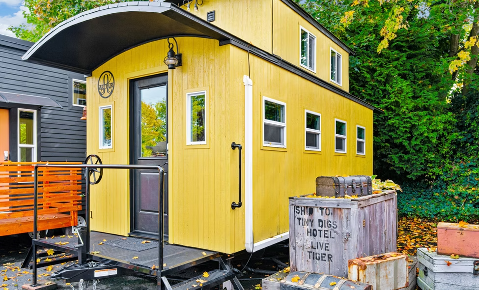 Tiny Digs Hotel yellow tiny house exterior