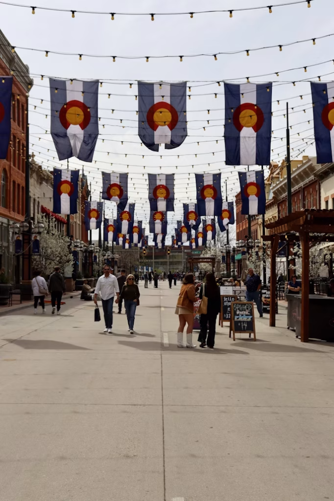 Pedestrian street in Denver with Colorado flags overhead