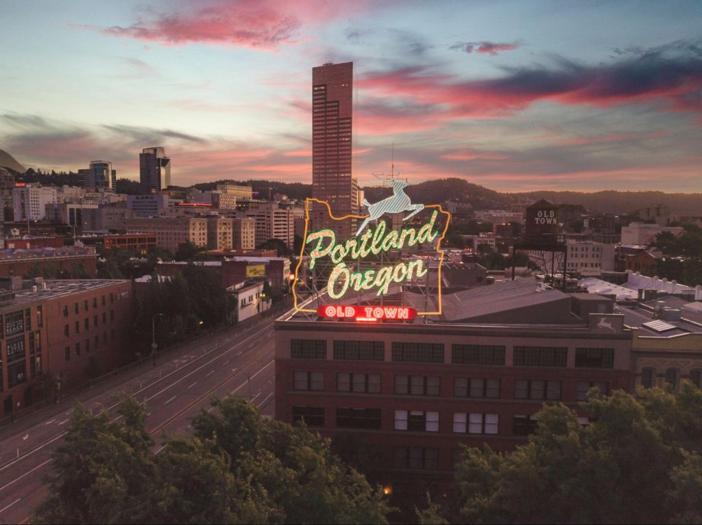 Portland skyline at sunset with Old Town sign